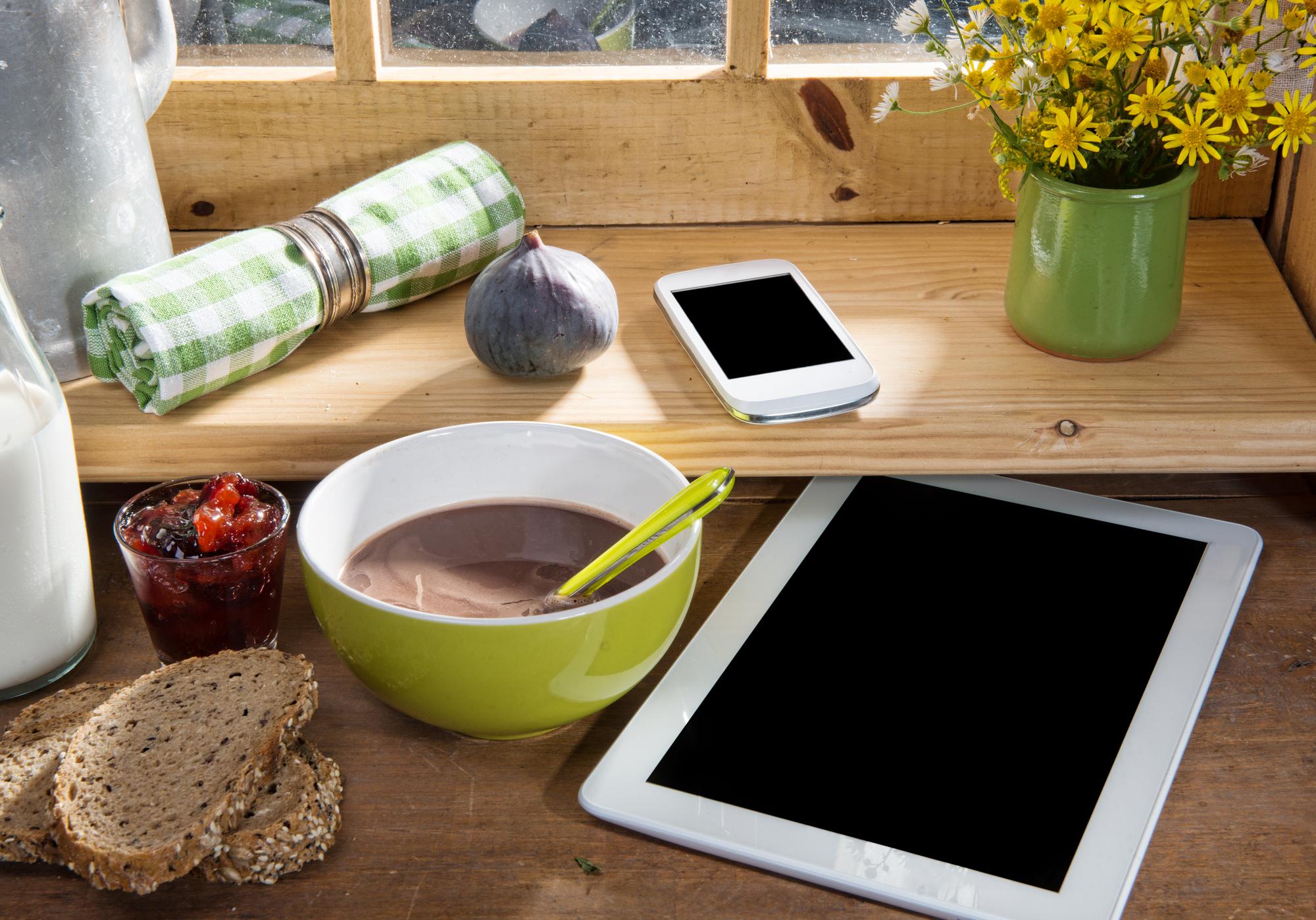 Stack of recipe binders and a tablet